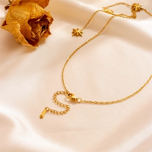 Elegant gold stainless steel hexagram star tassel necklace on champagne silk fabric