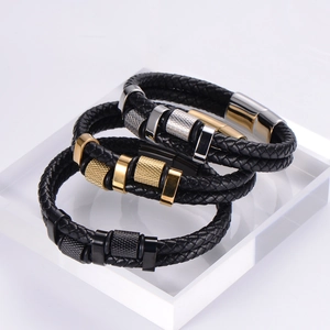Detail of multi-layer braided leather bracelets with gold and silver magnetic buckles