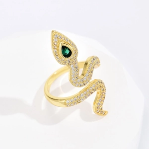 Close-up of 18K gold snake ring with white pavé zircons and a pear-cut green stone
