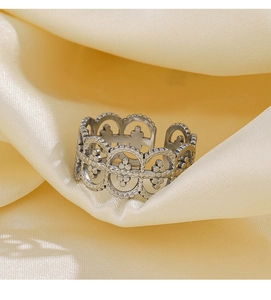 Detailed close-up of vintage hollow lace pattern on silver stainless steel open ring