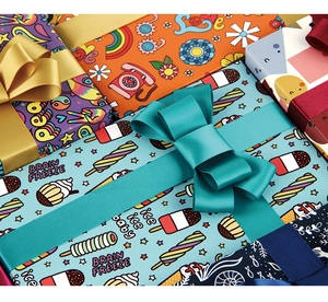 Close-up of colorful pop art gift wrapping paper with satin ribbons and festive bow details