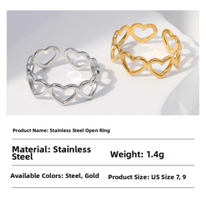 Detail showing gold and steel stainless steel open rings with hollow heart pattern