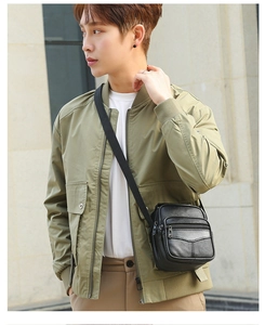 Detailed view of the multi-zipper compartments and lychee grain leather on men's crossbody bag