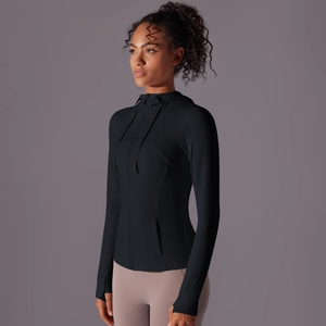 Detail view of women's black yoga jacket with thumbhole cuffs and slim fit design