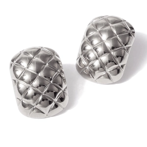 Detailed view of silver rhombic pattern earrings with polished metallic finish