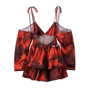 Detail of red floral smocked back and adjustable spaghetti straps on tiered dress