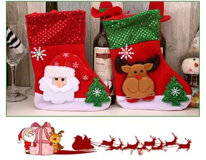 Detail view of plush red Christmas stockings with reindeer and Santa Claus character icons