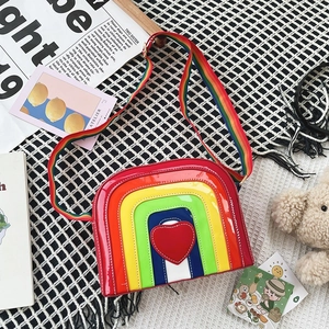 Detail of a rainbow heart crossbody bag in shiny patent leather with adjustable strap