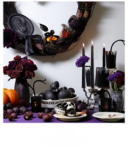 Gothic Halloween decor scene with bleeding candles, skull model and floral wreath details