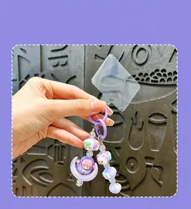 Close-up of cute character beads and moon pendant on a purple beaded phone strap keychain