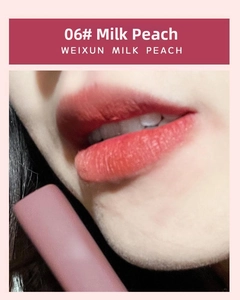 Macro close-up of matte velvet lipstick in Weixun Milk Peach shade with frosted tube
