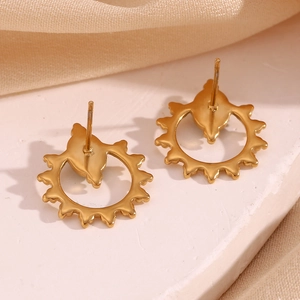 Detailed close-up of golden hollow sunflower earrings with oval blue turquoise stones
