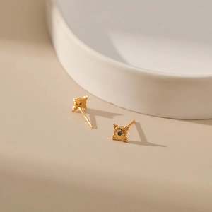18K gold plated brass stud earrings with evil eye design and blue center stone accents