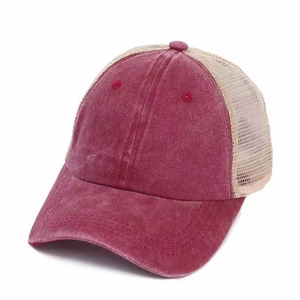 Detail view of vintage red trucker hat with breathable beige mesh and washed cotton finish