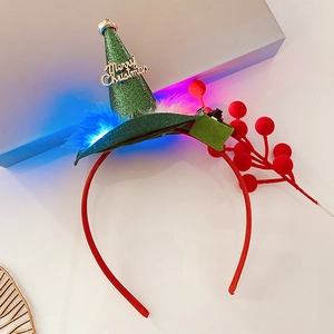 Close-up of a green sequin Christmas hat headband with white feathers and blue LED lights