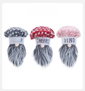 Detailed front view of three festive gnome wine bottle covers with knitted dot hats