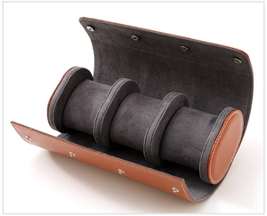 Detail view of leather watch roll with three slots and grey velvet lining in brown-orange