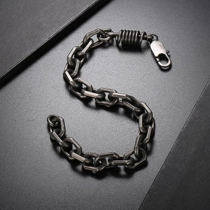 Macro detail of industrial style titanium steel chain bracelet with lobster clasp finish