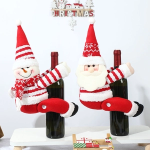 Knitted Christmas wine bottle covers featuring Santa and Snowman holiday decor