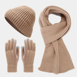 Detailed view of beige knitted winter set including beanie, scarf, and touchscreen gloves