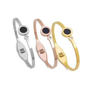 Three minimalist titanium steel open bangles with roman numerals in gold, rose gold and silver