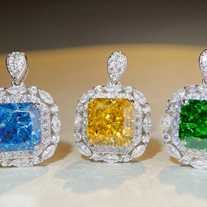 Square emerald cut gemstone necklaces in blue, yellow, and green with diamond halos