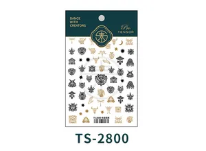 Detail view of Greek totem nail stickers featuring gold and black dragonfly and moon designs