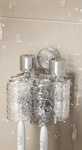 Detail of vacuum suction wall mount toothbrush holder with two textured cups on tile wall