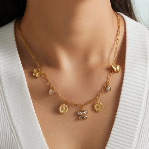 Gold butterfly sunflower pendant necklace with zircon crystals worn by a model