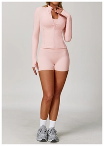 Detailed view of pink zipper yoga jacket featuring thumb holes and high-stretch fabric