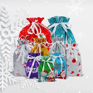 Assorted colorful Christmas drawstring gift bags with festive patterns and ribbon ties