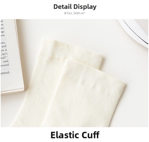 Detailed close-up of white ribbed cotton socks featuring elastic cuff and soft texture