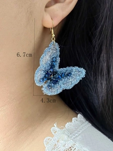 Detailed close-up showing light blue crystal woven butterfly earrings and exact dimensions