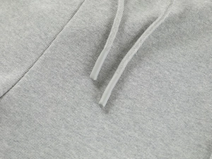 Macro detail of light grey yoga shorts featuring knit fabric texture and frosted drawstring