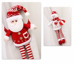 Detail of knitted Santa and Snowman curtain tiebacks with wooden buttons for Christmas