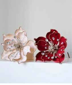 Detail of velvet magnolia flowers with gold glitter edges and rhinestone stamens
