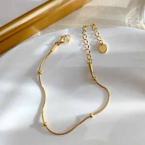 Minimalist gold plated snake chain bracelet with small beads and heart charm