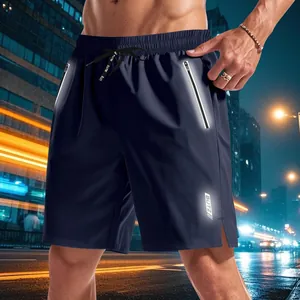 Detail of dark blue reflective running shorts with adjustable drawstring and logo