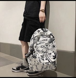 Detail of artistic black and white graffiti canvas backpack with Angel and Love prints