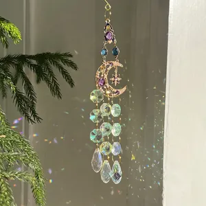 Golden moon and star suncatcher with multi-colored crystals creating rainbow reflections