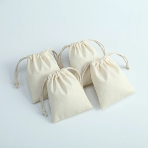 Detailed close-up of natural cotton linen drawstring bags with woven texture and cords