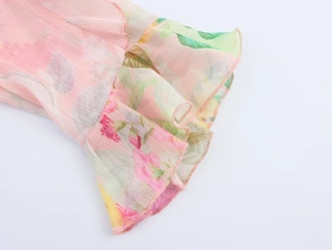 Detailed view of floral ruffle cuffs and fine stitching on a pink poplin shirt