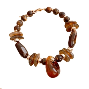 Brown geometric resin necklace with large teardrop pendant and golden metal hardware