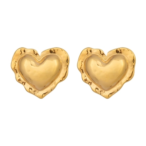 Detailed view of 18K gold heart earrings with unique irregular hammered texture edges