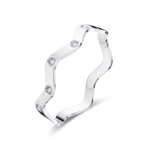 Polished wavy stainless steel bangle with five sparkling zircons on white background