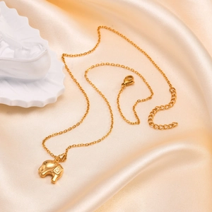 Detail of a vintage golden elephant pendant on an O-chain with adjustable lobster clasp