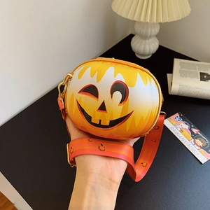 Halloween pumpkin crossbody bag with smiley face and adjustable patterned shoulder strap