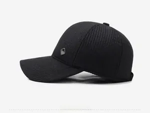 Detail view of black textured baseball cap with ear flaps and side brand patch