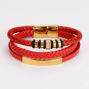 Macro detail of red multilayer braided leather bracelet with golden magnetic clasp