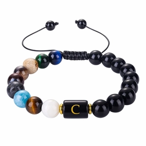 Detail of 10mm black agate bead bracelet with tiger eye stones and golden letter C